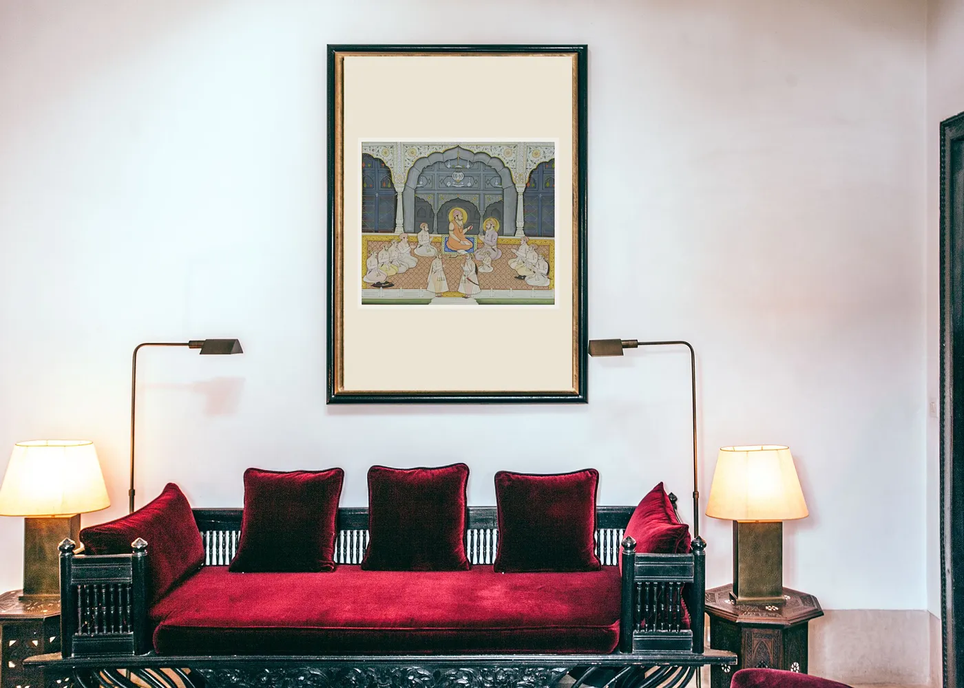 Mughal Court miniature painting above a red velvet sofa